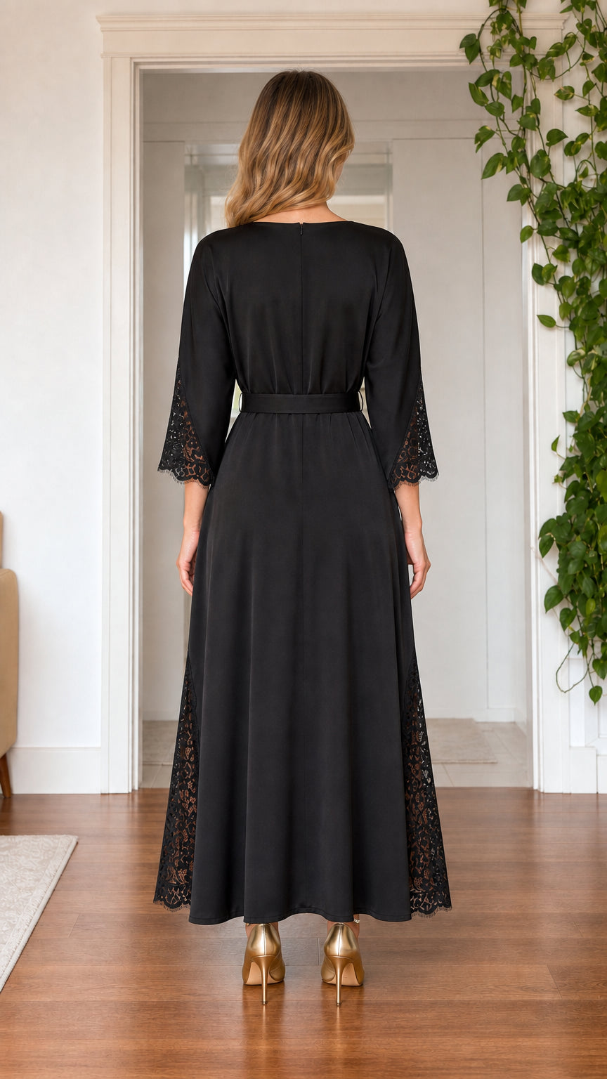 Back view of model wearing black satin boatneck maxi dress with belt