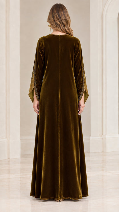 Back view of woman wearing full length olive green velvet kaftan dress