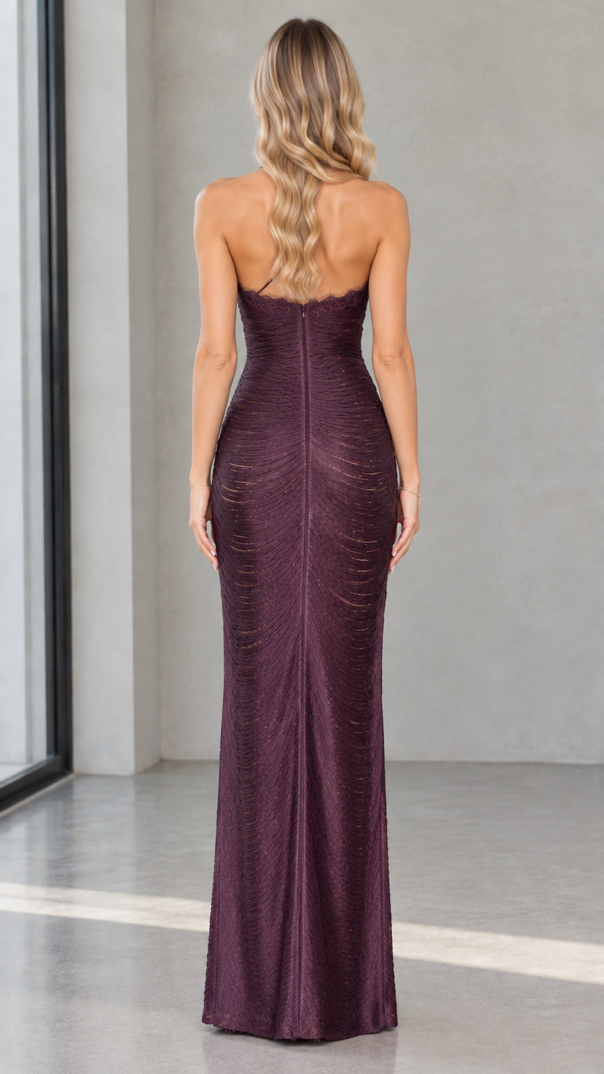 Back view of model showing open back design of Deep Plum maxi evening dress