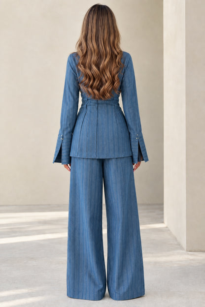 Back view of women's blue long sleeve button-up top and wide-leg trousers