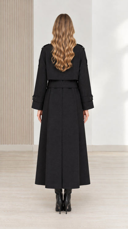 Back view of women's black full-length trench coat