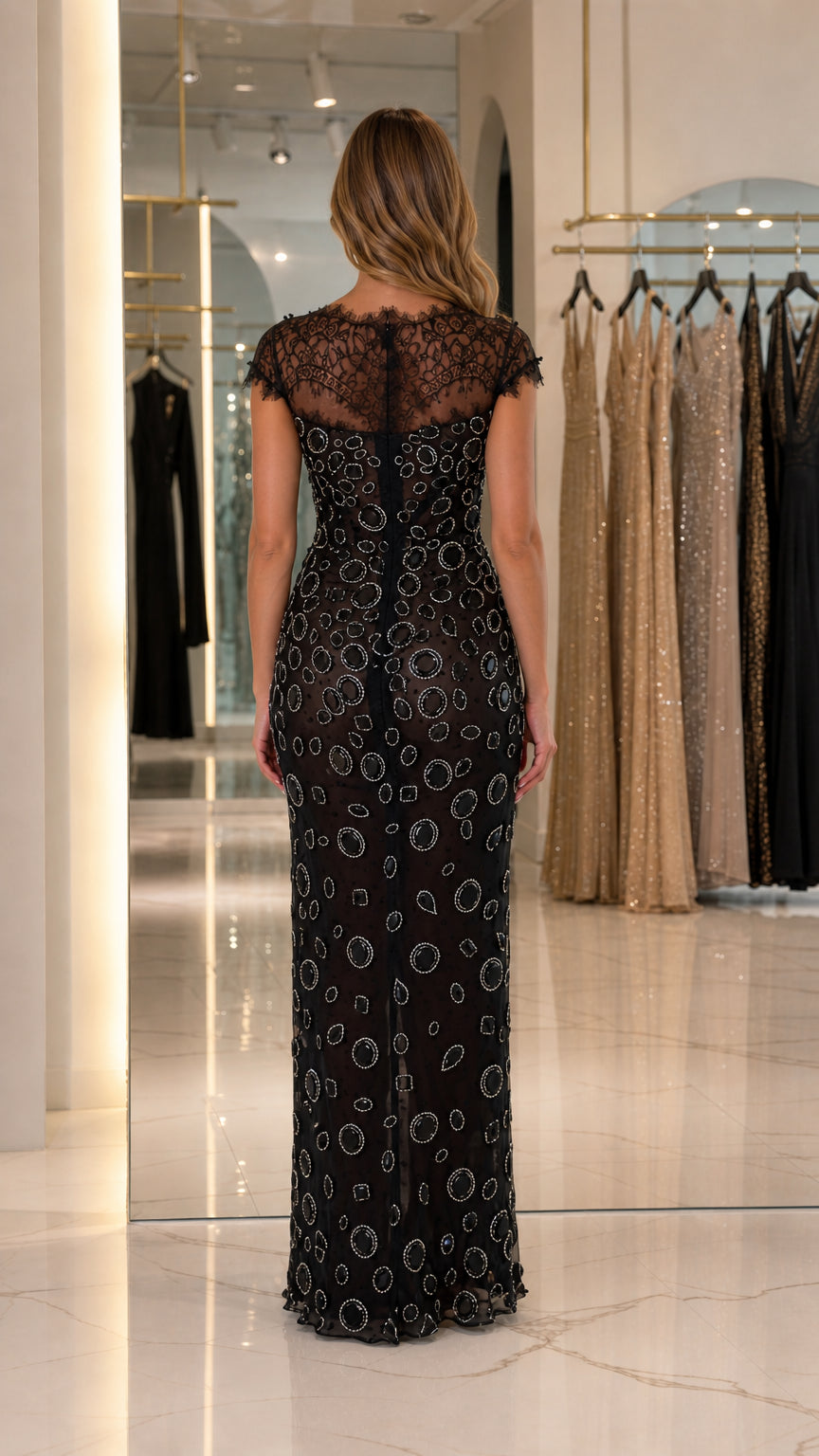 Back view of black formal gown showing sheer eyelash lace back and zip closure