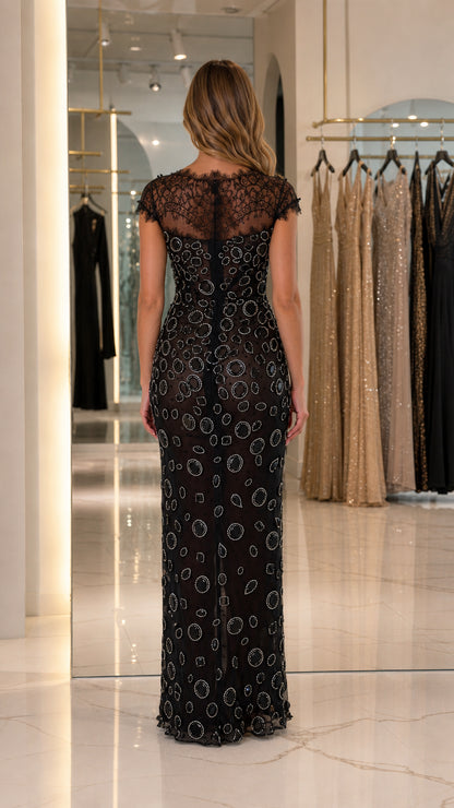 Back view of black formal gown showing sheer eyelash lace back and zip closure