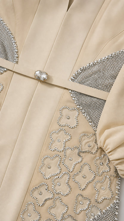 Close-up of rhinestone buckle and floral beadwork on Champagne gown