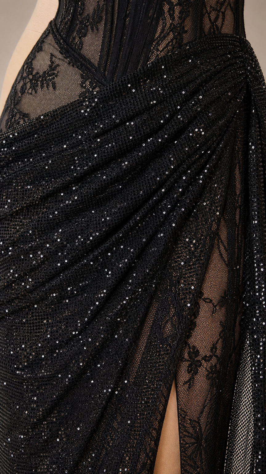 Close-up detail of sparkling black draped mesh and sheer lace boning