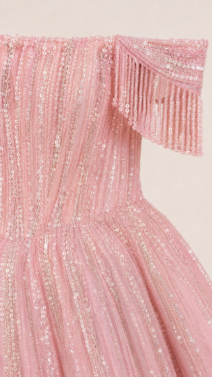 Close-up detail of pink sequin embellishment and beaded fringe shoulder strap