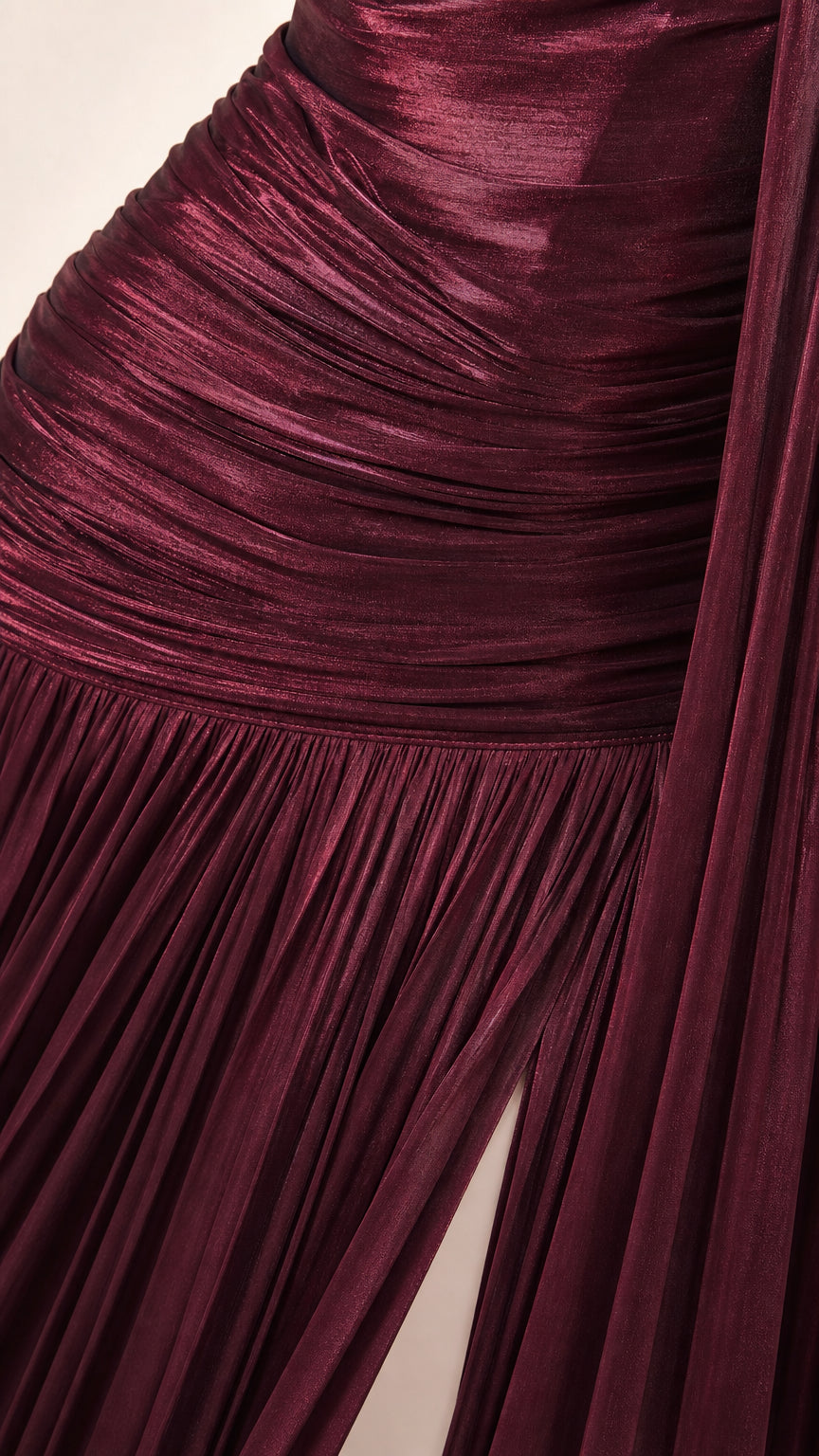 Close-up of burgundy metallic plissé fabric texture and ruched bodice detail