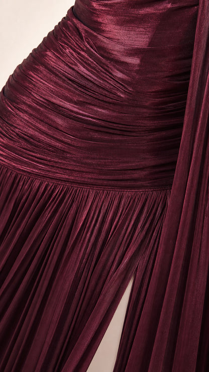 Close-up of burgundy metallic plissé fabric texture and ruched bodice detail