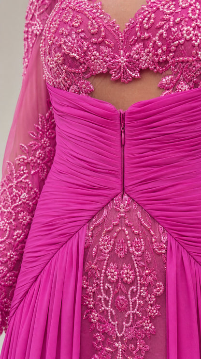 Close-up detail of fuchsia pink gown showing intricate beading, cutout, and ruched waistband
