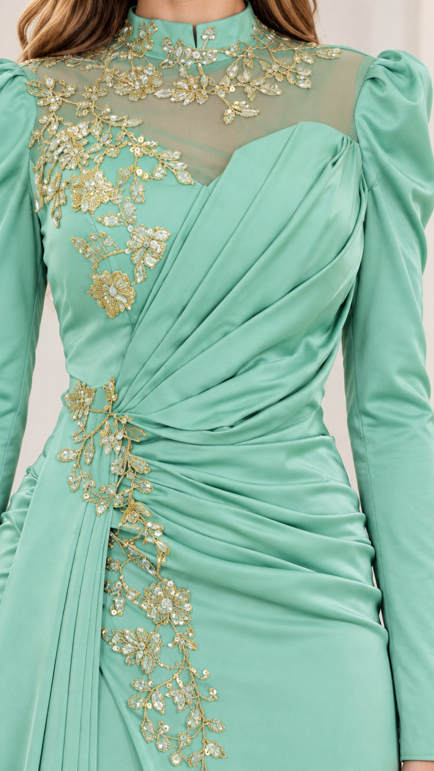 Close up view of mint green bodice sheer mesh neckline and gold floral embroidery