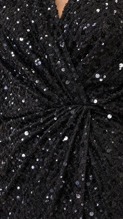 Close-up detail of black sequin fabric and gathered twist waist knot