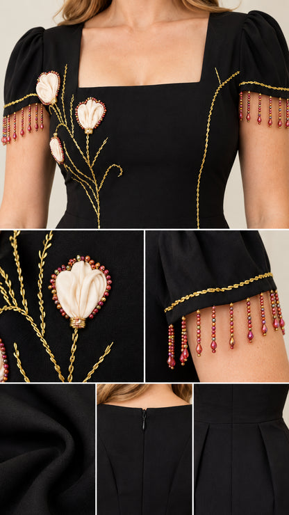 Close-up details of floral appliqué, beaded fringe trim, and back zipper on black dress