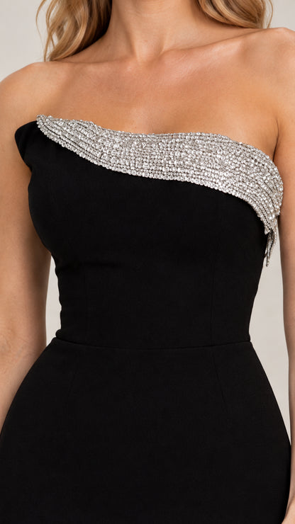 Close-up of sparkling rhinestone trim along the strapless neckline on black dress