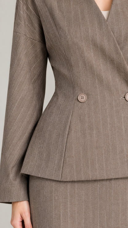 Close-up detail of double button closure and waist pleats on taupe pinstripe suit