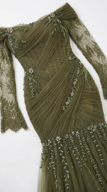 Flat lay close-up of ruched olive green tulle bodice with beaded floral embroidery and lace sleeve