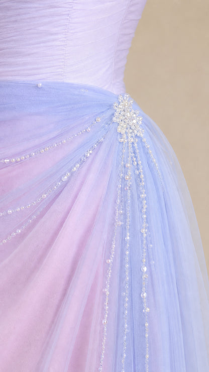 Close-up detail of side waist crystal beading and draped pearls on pastel tulle gown