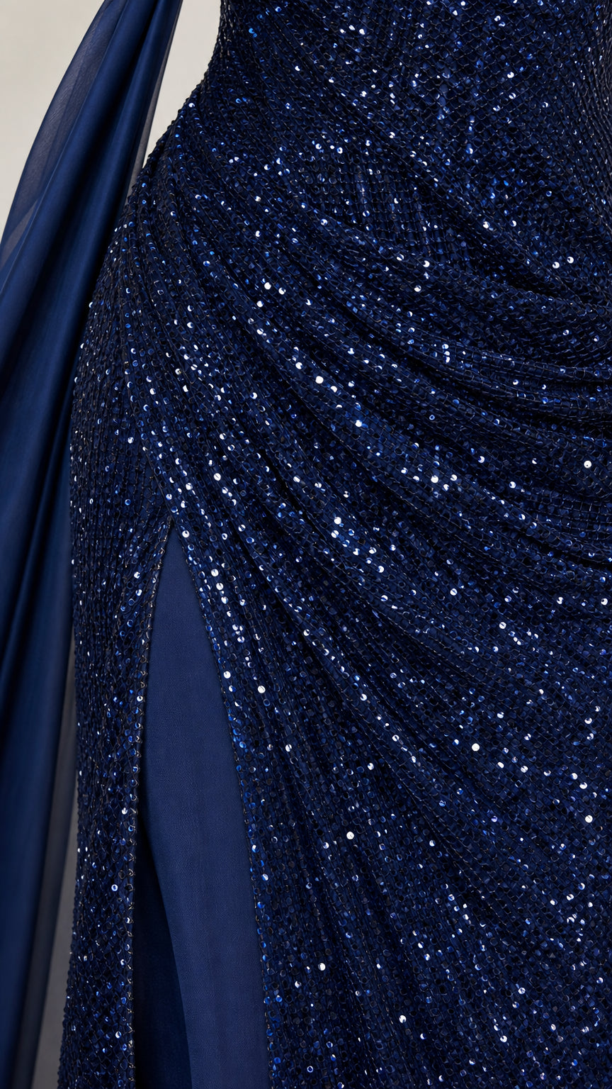 Close-up texture view of intricate navy blue sequins and ruched fabric craftsmanship