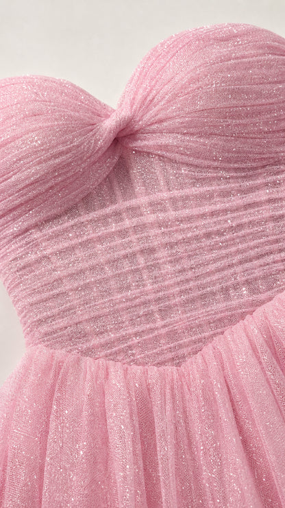 Close-up detail of pink ruched sweetheart bodice with glitter tulle fabric