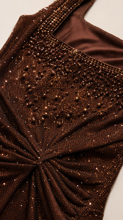 Close-up detail of beaded embellishments and ruched gathered waist on brown shimmer fabric