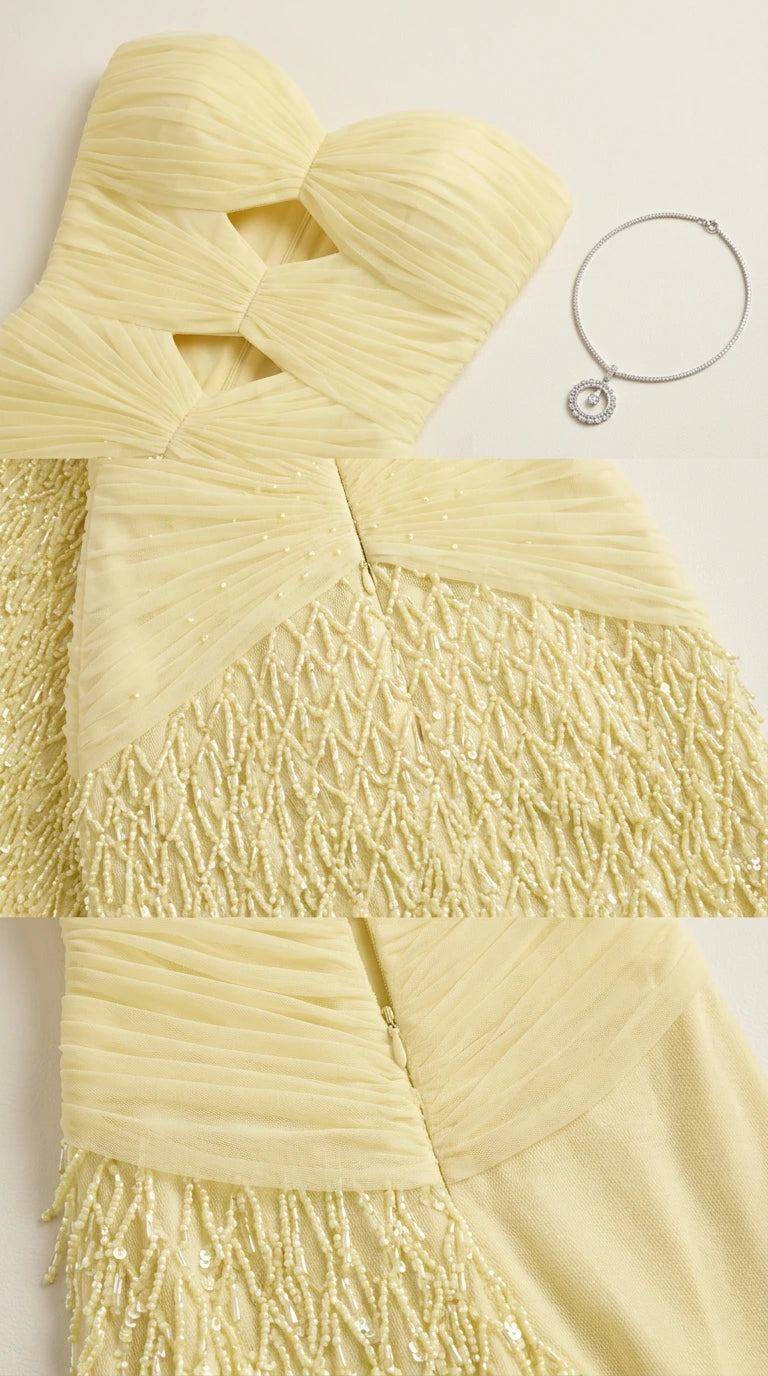 Close-up detail of pale yellow ruched fabric, front cutouts, and textured embellishment