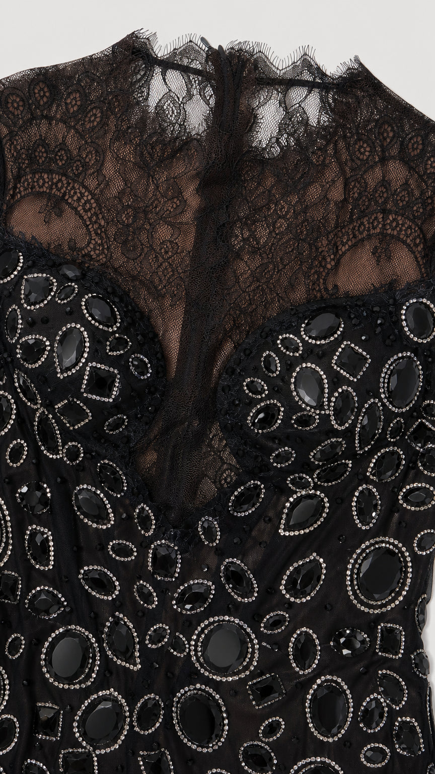 Detailed close-up of intricate beaded embellishments and eyelash lace neckline
