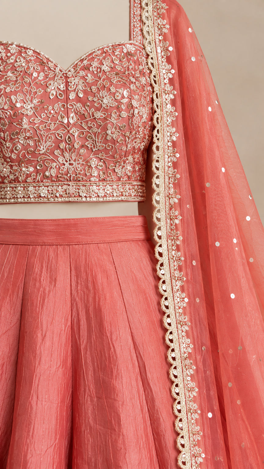 Close-up of delicate floral embroidery on crop top and sheer dupatta border