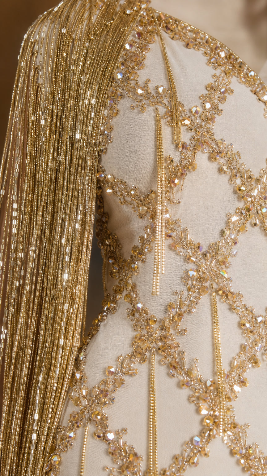 Close-up detail of intricate gold beadwork, sequins, and hanging beaded fringe
