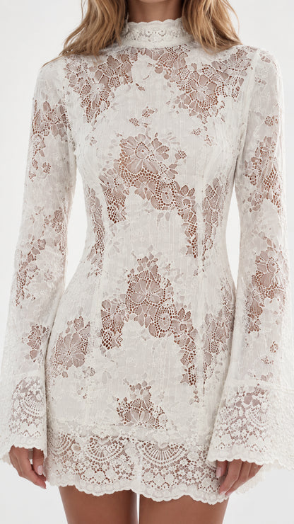 Close-up detail of textured floral lace fabric on high neck dress
