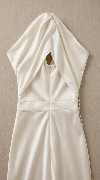 Close-up detail of back zipper and delicate button fastening on ivory dress