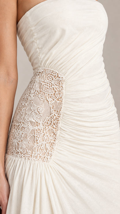 Close-up detail of delicate floral lace inset and waist ruching