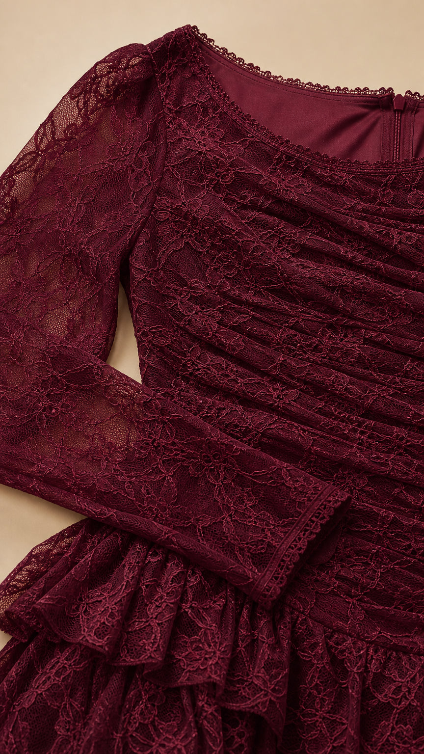 Close-up of ruched floral lace bodice and tiered ruffle detailing in burgundy