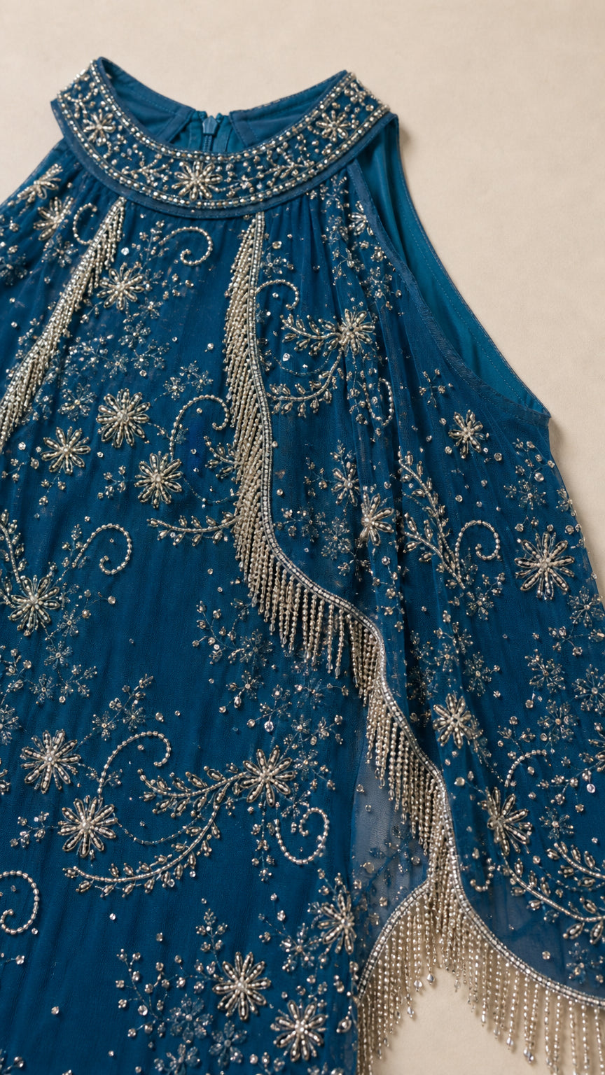 Close-up detail of Teal Blue embellished cape overlay, intricate beading, and fringe trim