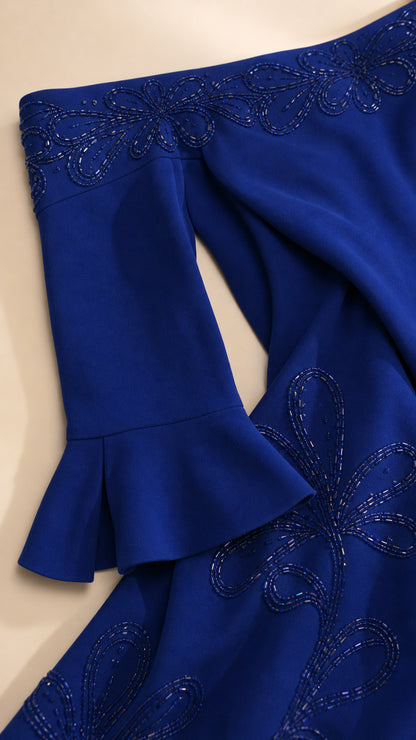 Close-up detail of tonal bead embroidery on the neckline and fluted cuff in Royal Blue