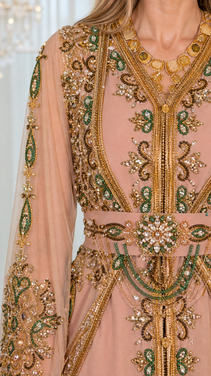 Close-up detail of gold embroidery, beadwork, and jewel-embellished belt on dusty pink kaftan bodice