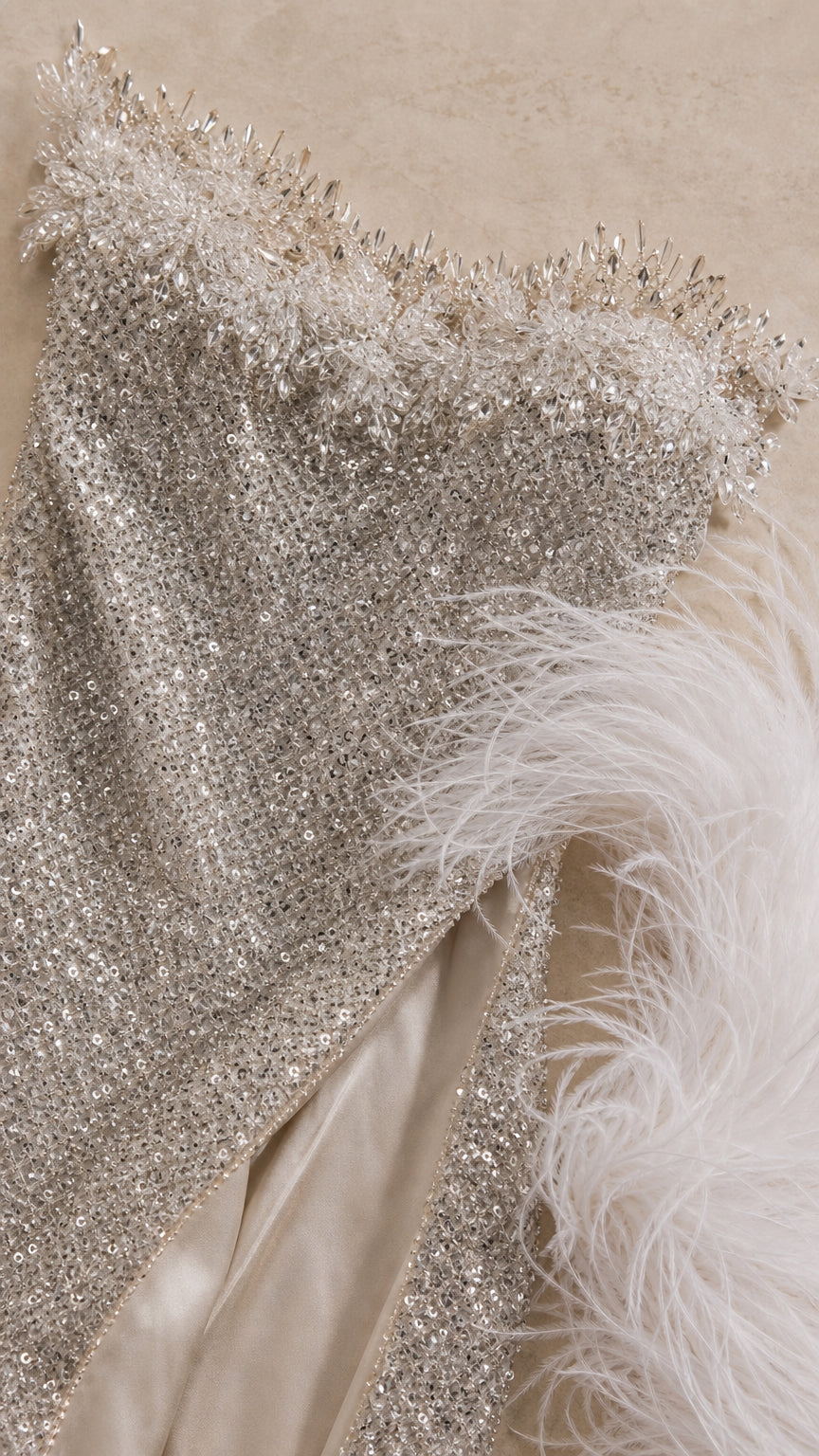 Close-up detail of beaded fringe neckline embellishment and sequin fabric