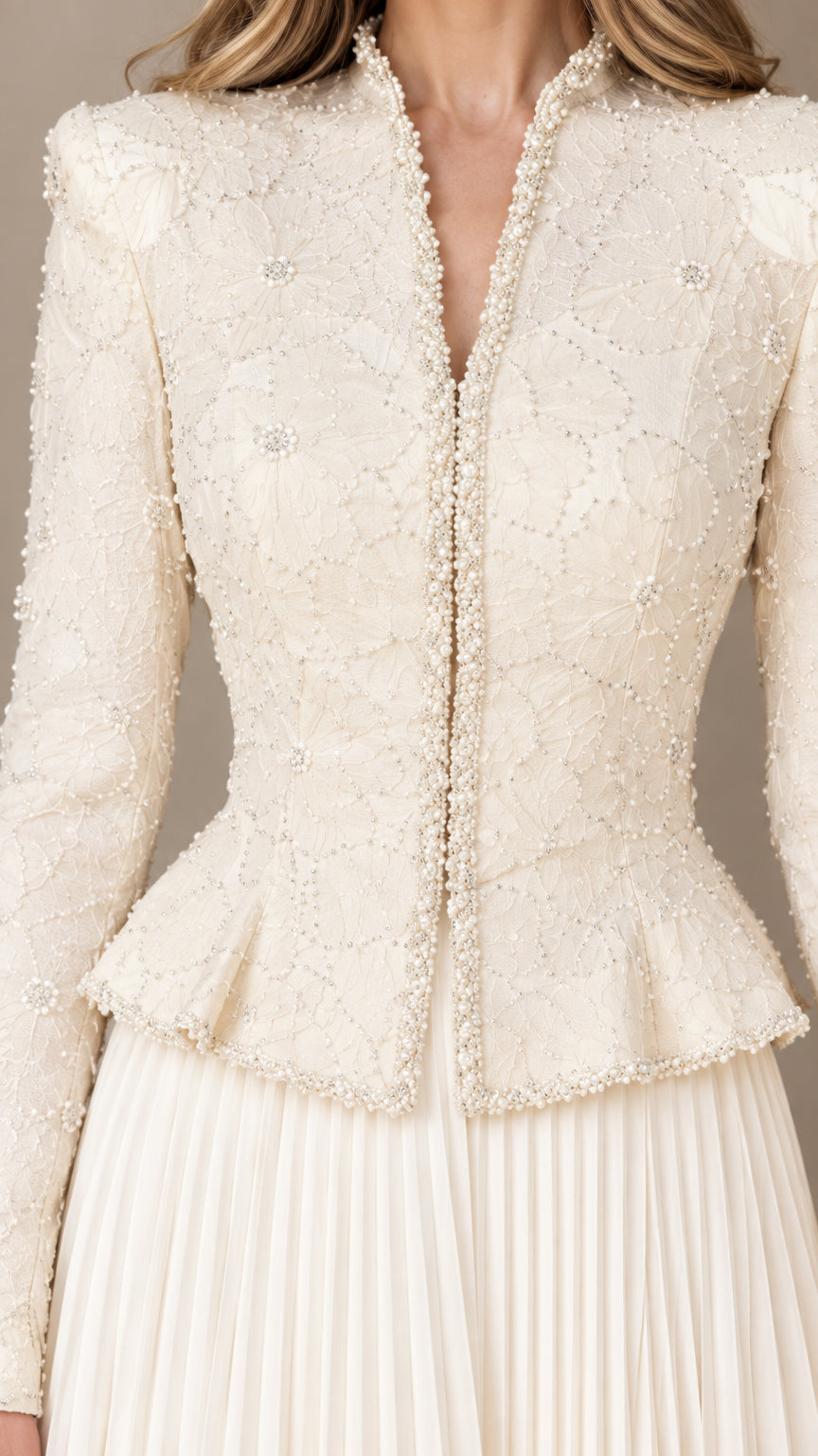 Close-up detail of delicate beadwork, neckline, and peplum hem on jacket