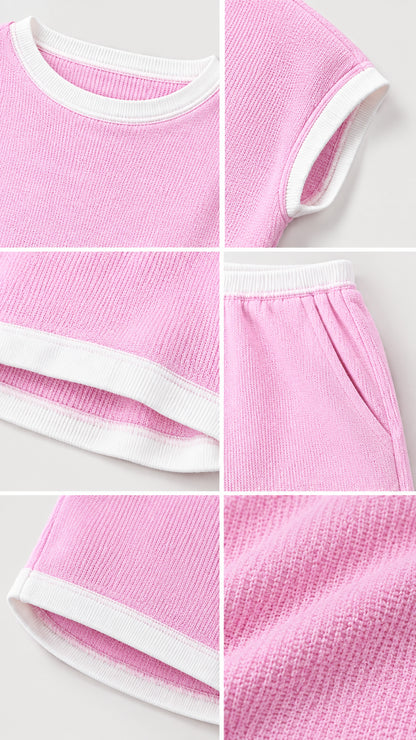 Detailed close-up of pink textured ribbed knit fabric and contrast white binding