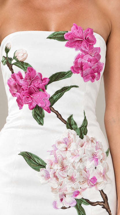 Close-up of pink floral embroidery and hydrangea detail on strapless bodice