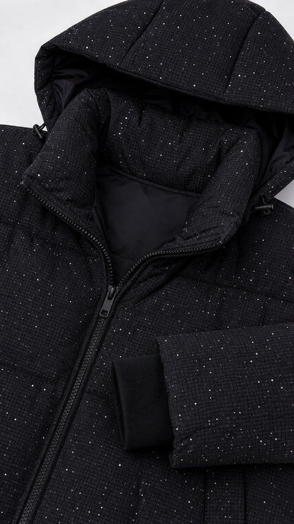 Close-up detail of black sparkly fabric texture, hood, zipper, and storm cuff