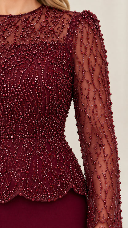 Close up detail of intricate beaded mesh bodice and scalloped peplum