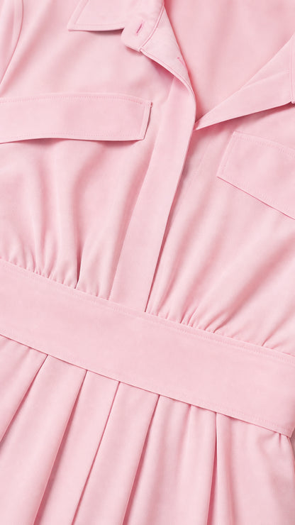 Close up detail of lapel collar, flap pockets, and waistband on pink dress