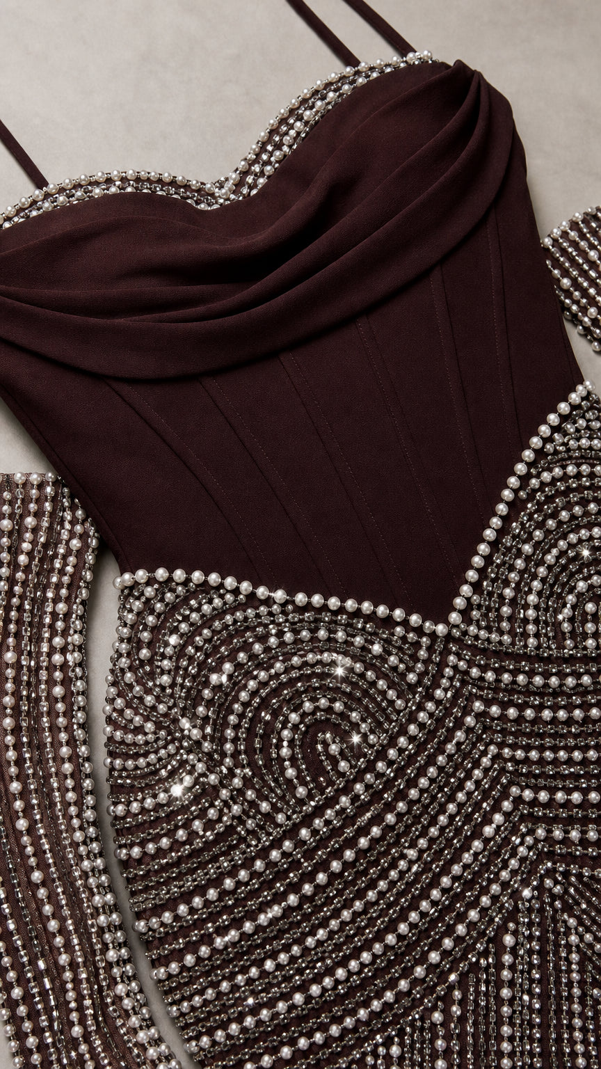 Close-up detail of burgundy draped corset neckline and pearl beaded accents