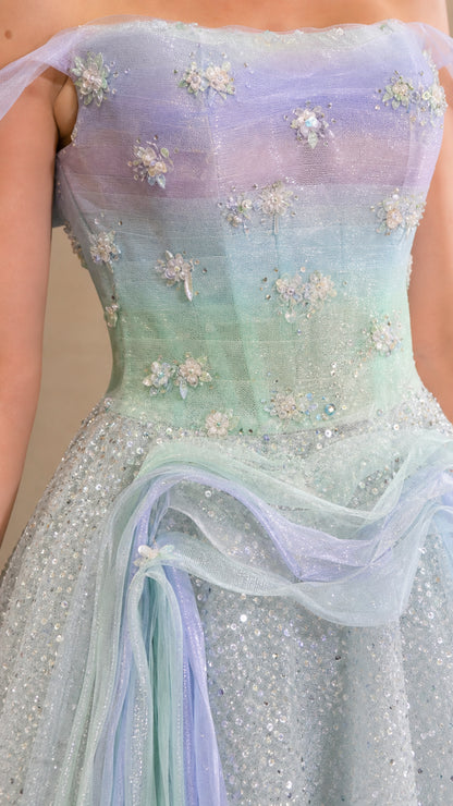 Close-up detail of bodice with 3D floral appliqués, beading, and soft pastel ombre fabric