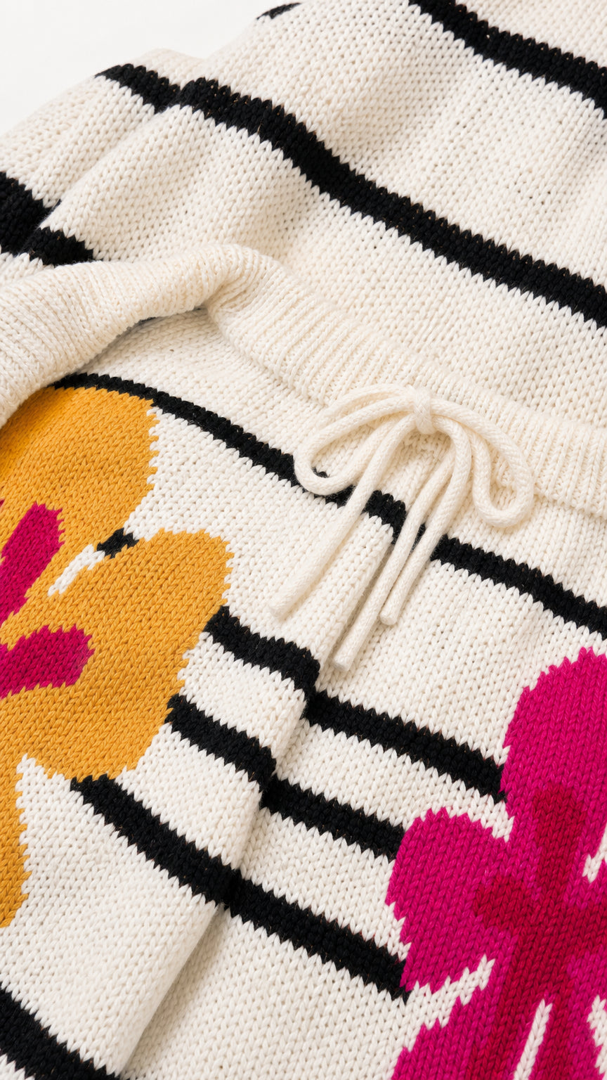 Close-up detail of knit texture, drawstring waistband, and floral pattern