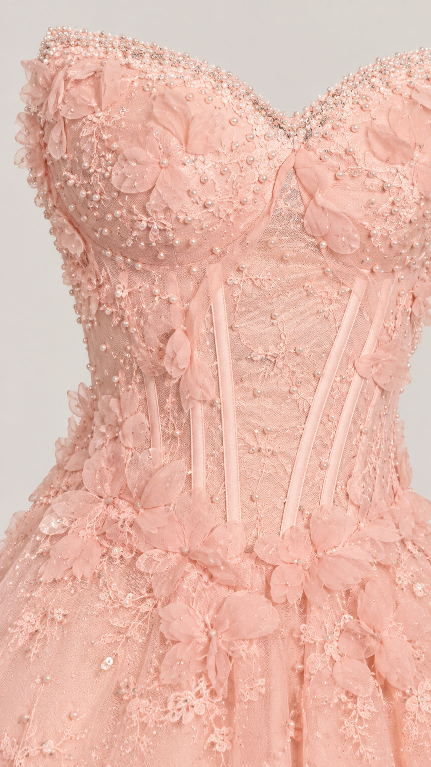 Close-up detail of bodice featuring sweetheart neckline, pearl beading, boning, and 3D floral lace