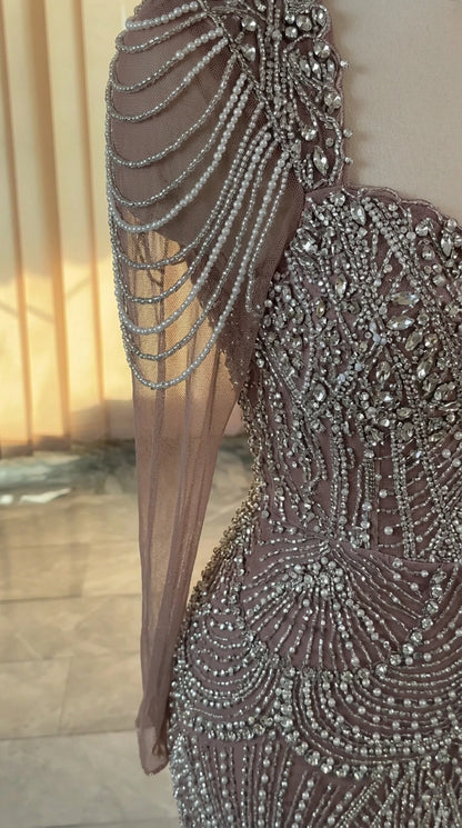 Close-up of intricate crystal beading and draped pearl shoulder sleeve detail
