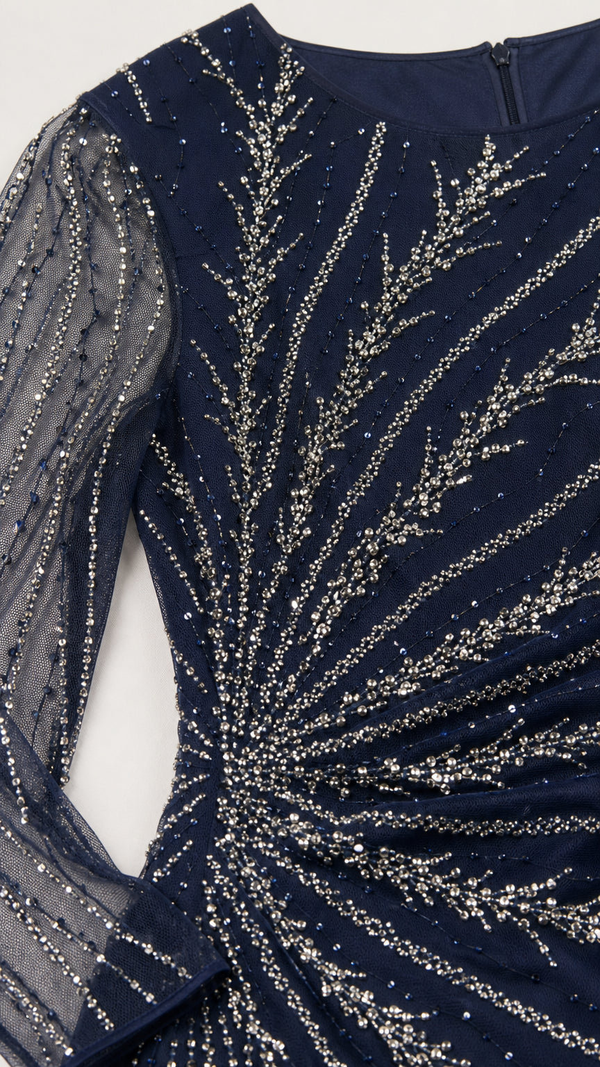Close-up detail of silver beading and sequins on navy blue mesh bodice