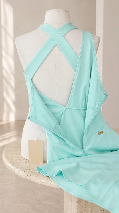 Interior and zipper craftsmanship detail on the aqua blue cross-back halter dress