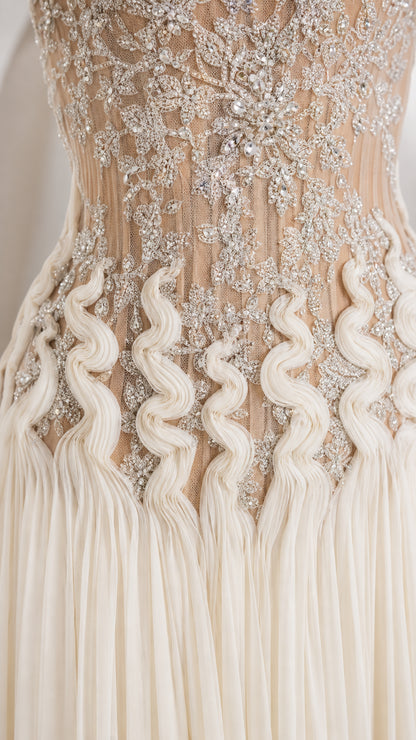 Close-up detail of intricate beadwork, embroidery, and wave ruching on bodice