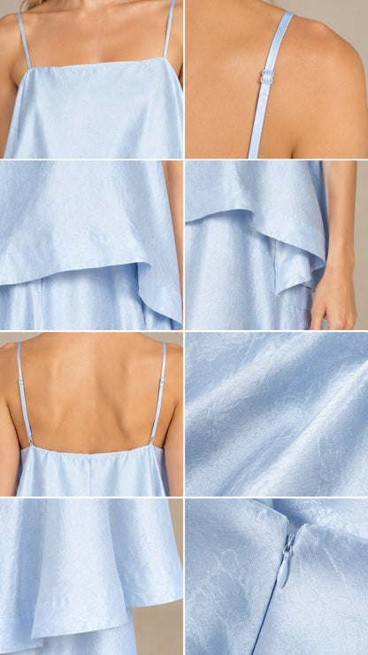 Detail view of light blue tiered cami dress straps, tiers, and zipper